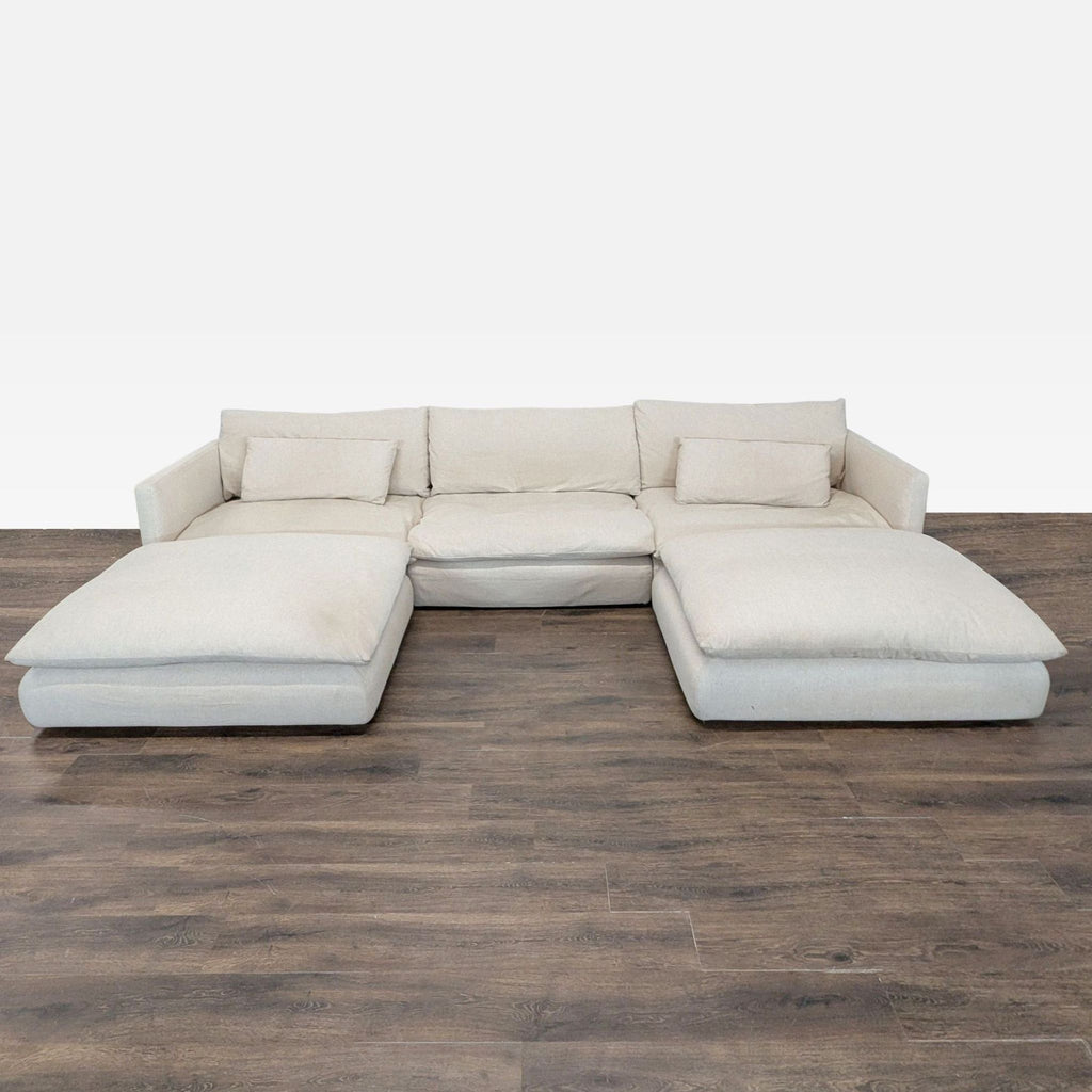 Spacious Crate & Barrel beige sectional with plush cushions and wide chaise lounges for modern comfort.  