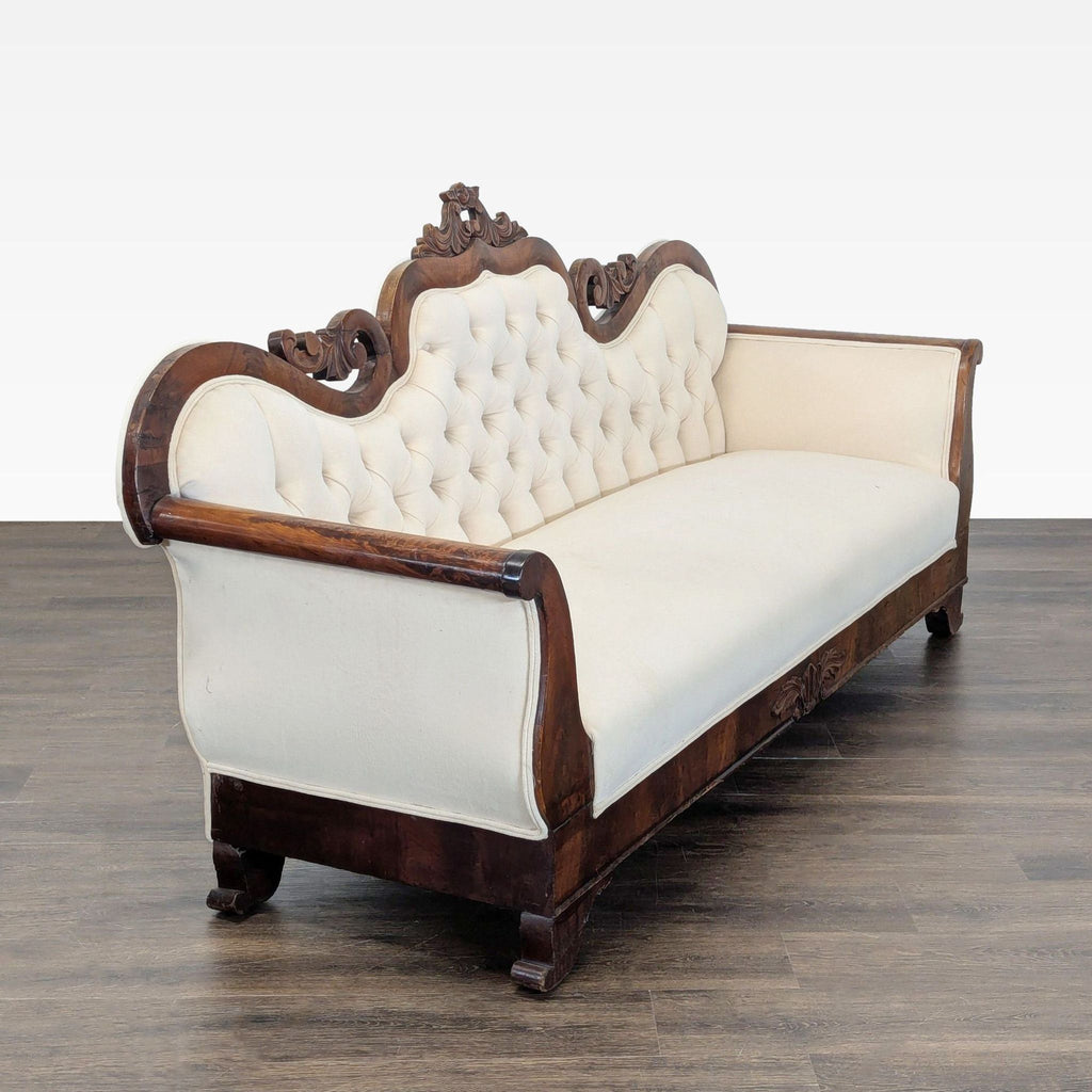 Cream tufted sofa with ornate wooden detailing, offering comfortable seating and timeless style for any 3-seat space.  