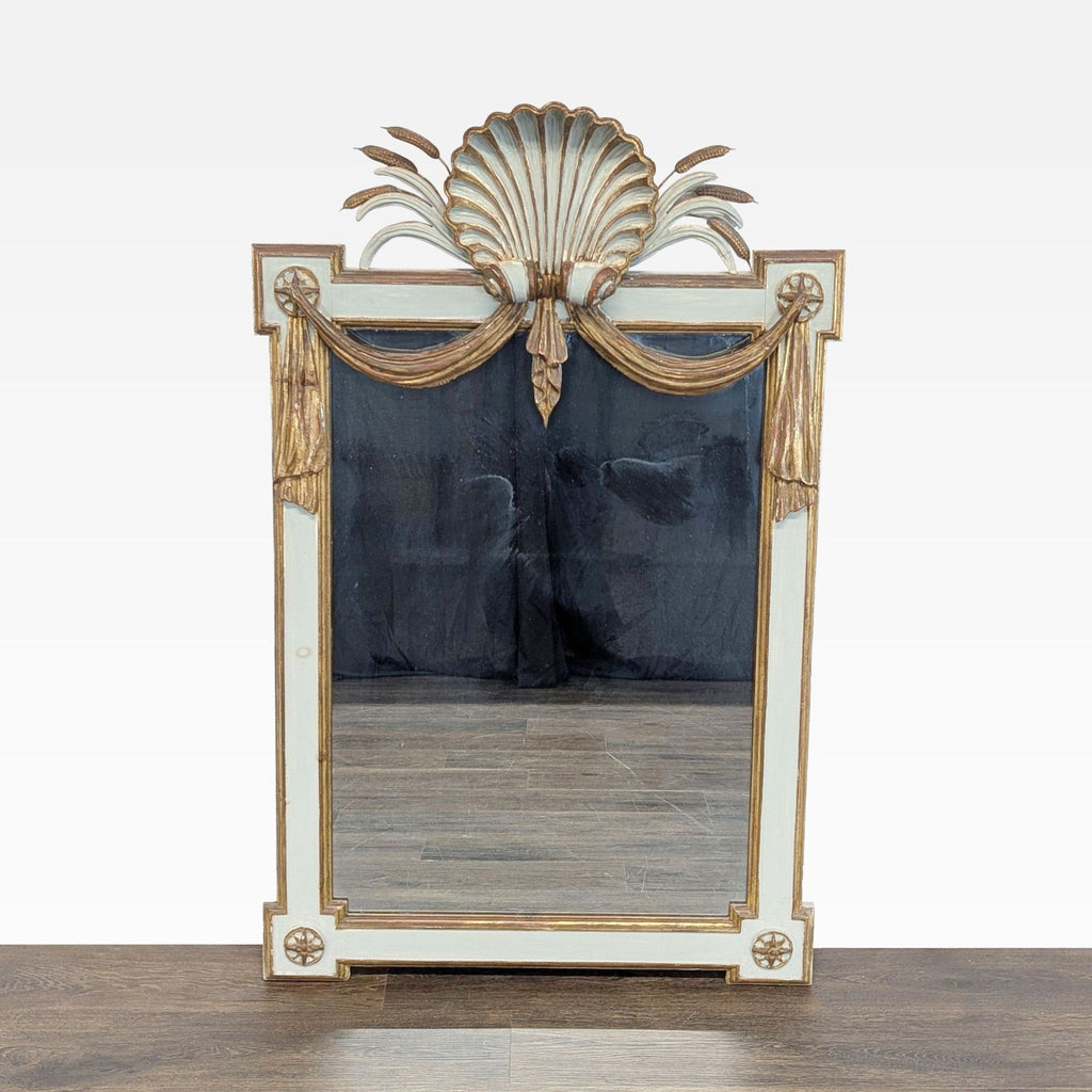 Antique mirror frame with carved shell, cattails, and decorative swag designs.