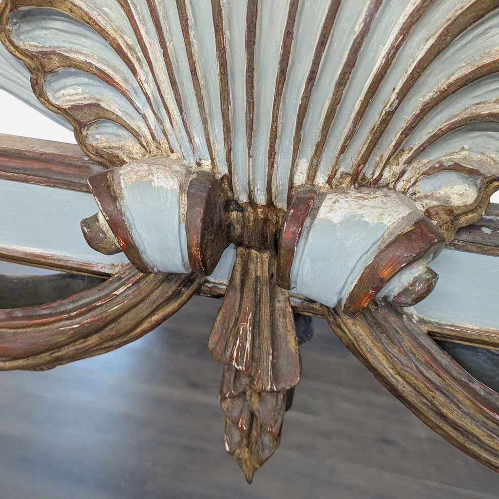 Ornate mirror adorned with shell motif, cattail carvings, and hanging swag details.