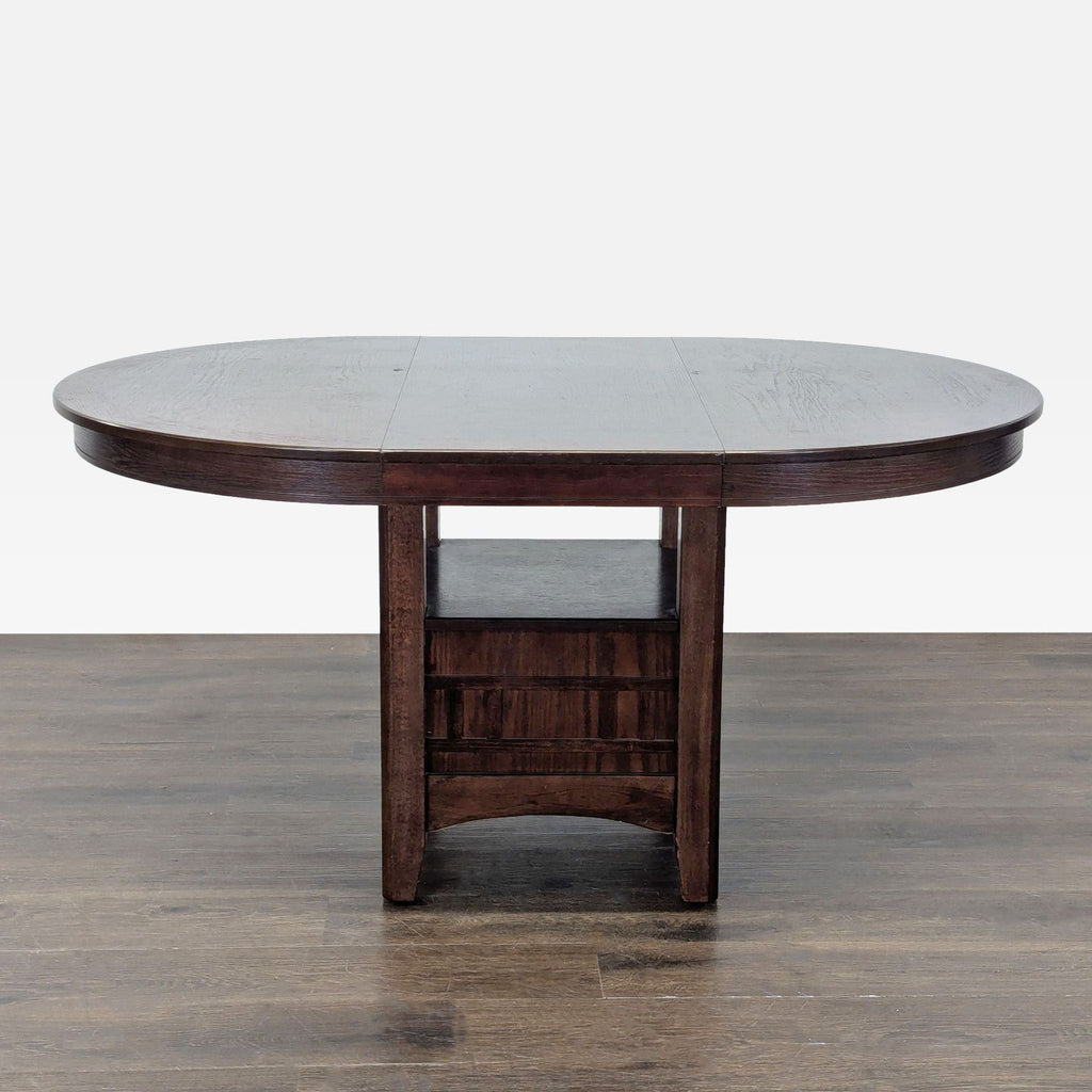 Classic dining set with an extendable round table and four upholstered chairs, ideal for kitchens or dining rooms.