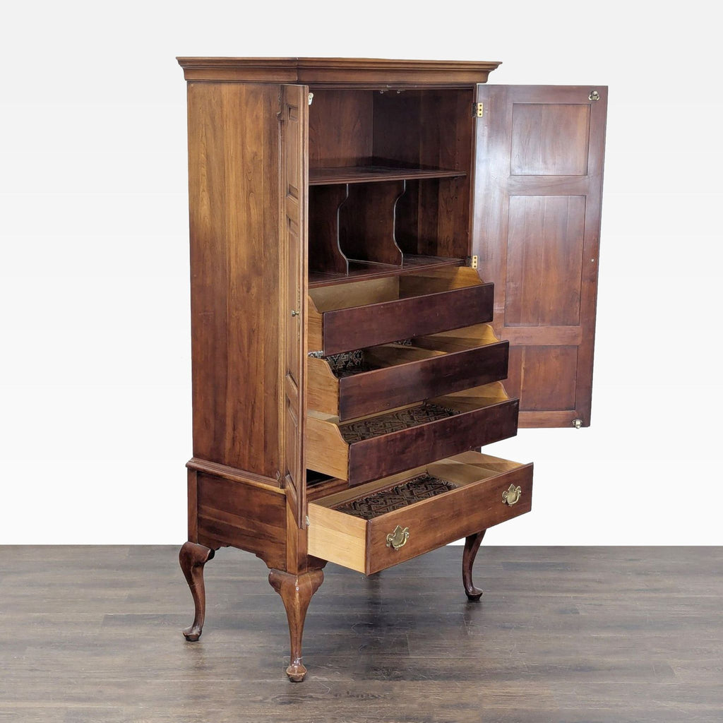 2. Open cherry armoire showing three interior drawers, large bottom drawer, and shelving; Statton Furniture cabinet.