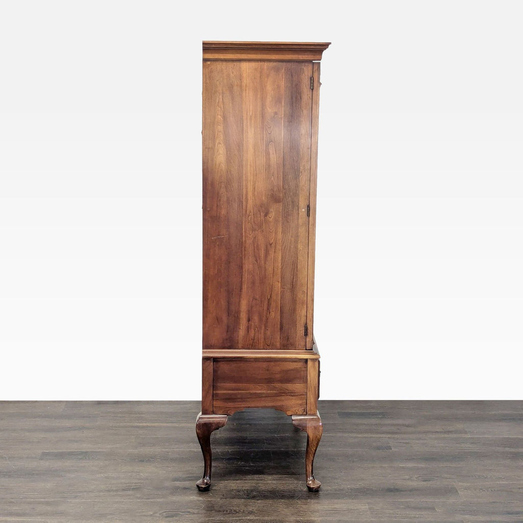 3. Side profile of Queen Anne cherry wood cabinet on curved legs by Statton Furniture, showing plain wooden finish.