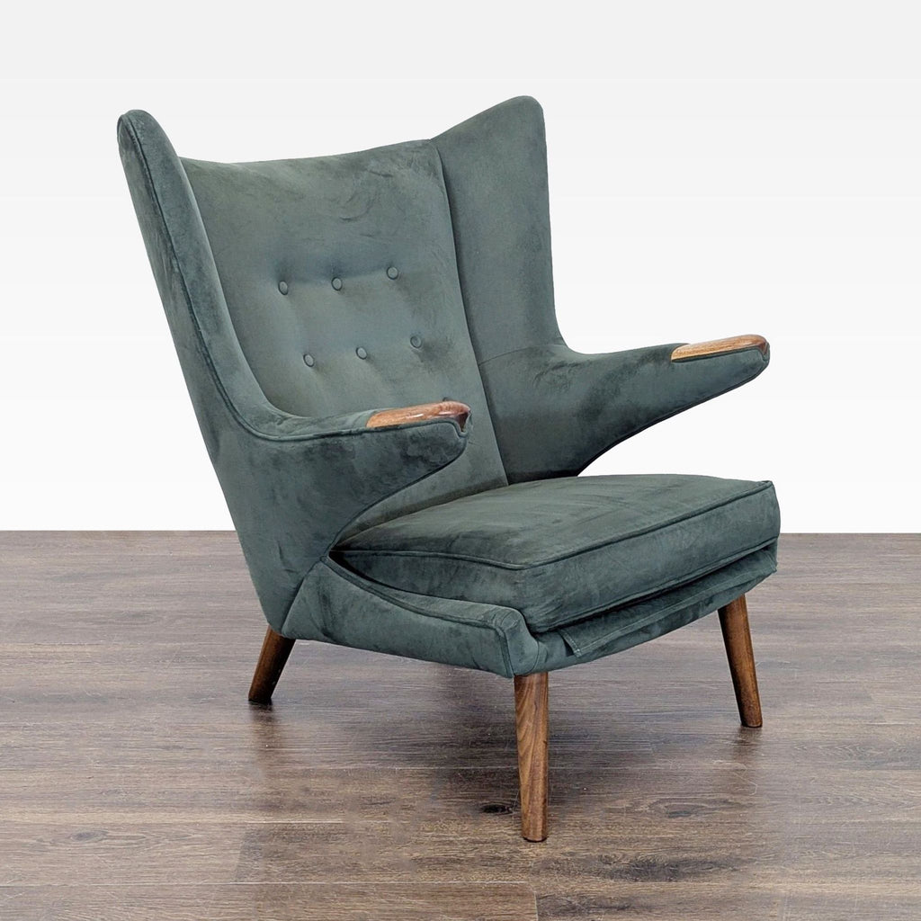 2. Side-angled view of a Hans Wegner lounge chair showing button-tufted back, winged arms, and sturdy wood accents.
