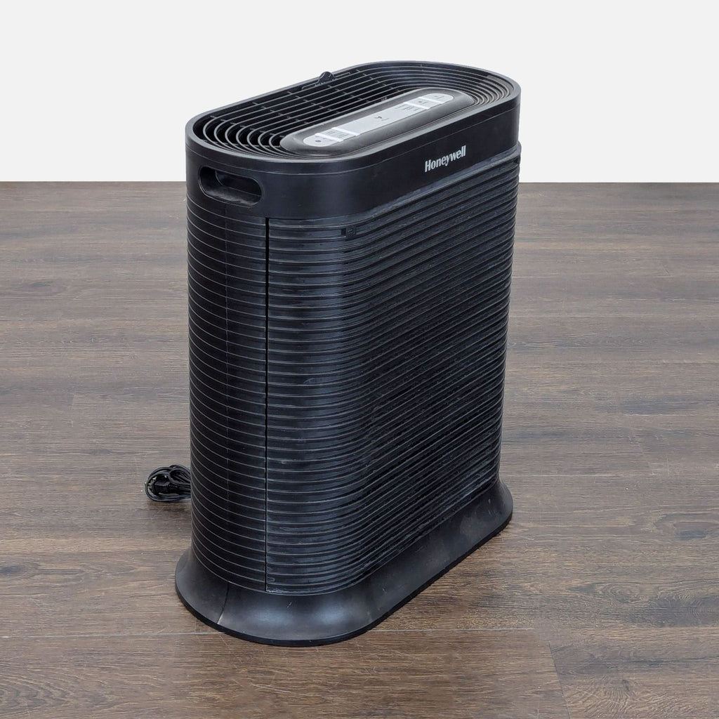 Compact Honeywell air purifier, user-friendly with power, clean, and turbo settings; shows filter status lights.