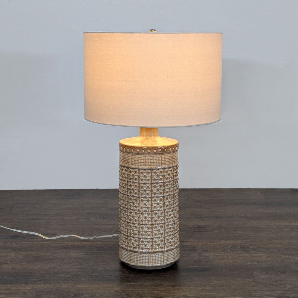 Pottery Barn ceramic table lamp with textured beige base and fabric drum shade, ideal for cozy lighting.