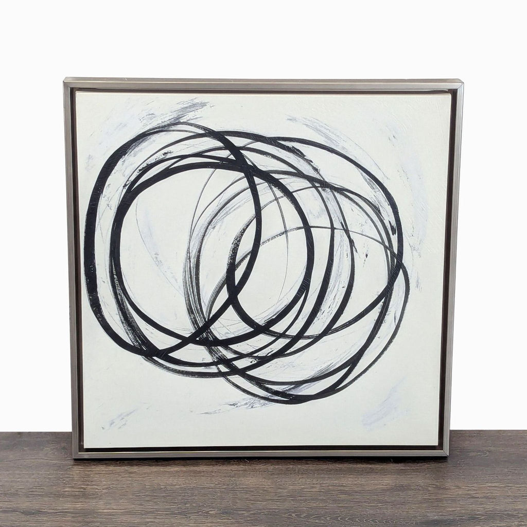 Framed abstract painting with bold black swirls on a white background, perfect for modern interior decor.