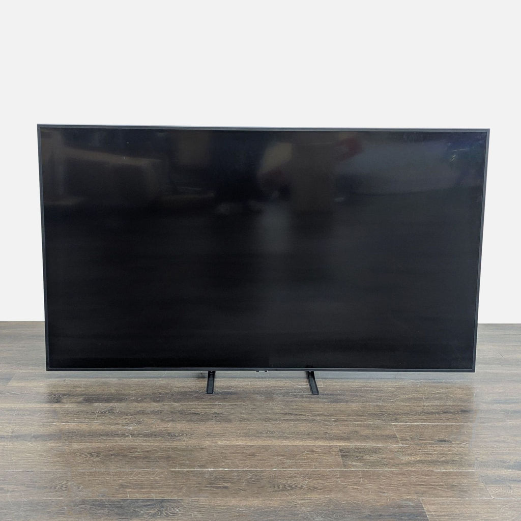 Samsung 65-inch 4K Ultra HD Smart TV with a vibrant display and original legs, in excellent condition.