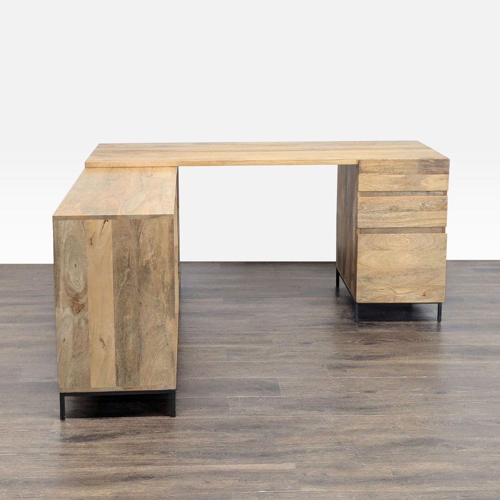 Modern L-shaped desk by West Elm, featuring sturdy wood, ample workspace, drawers, and shelves.