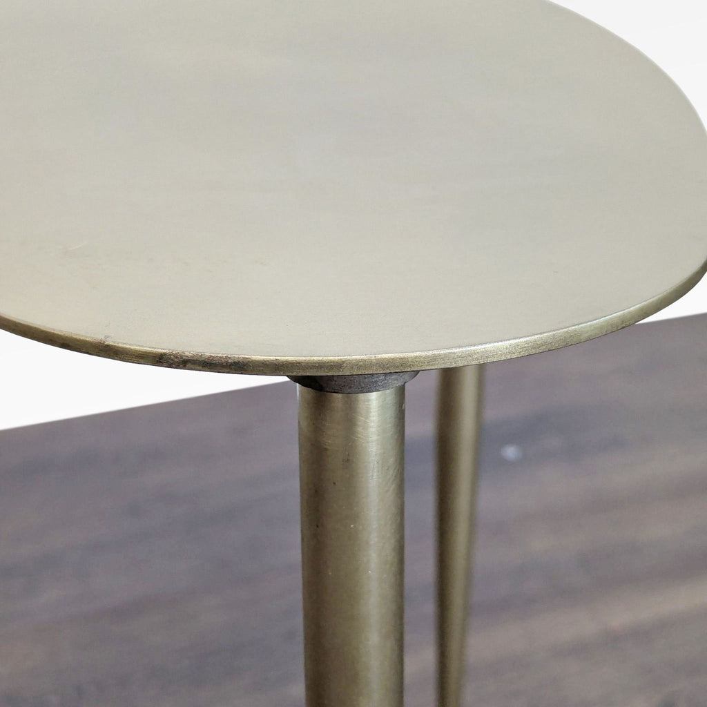 3. Close-up of a gold-finished table showing the rounded edge and sturdy metal legs, side & console table.