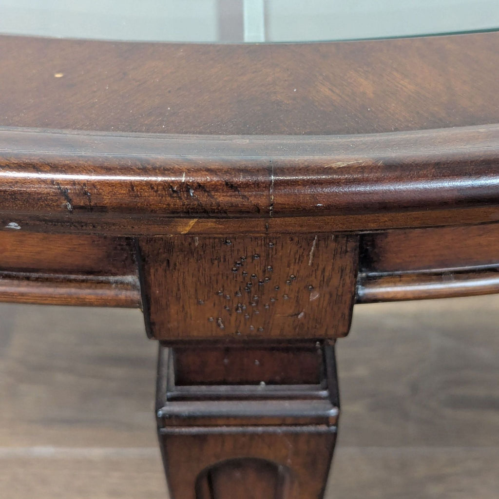 3. Detail of table leg junction, showing scratches, small dents, and visible wood imperfections.
