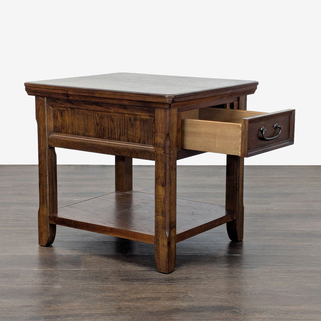 2. Sleek end table by Ashley Furniture, featuring sturdy legs and a compact tabletop for modern living spaces.  