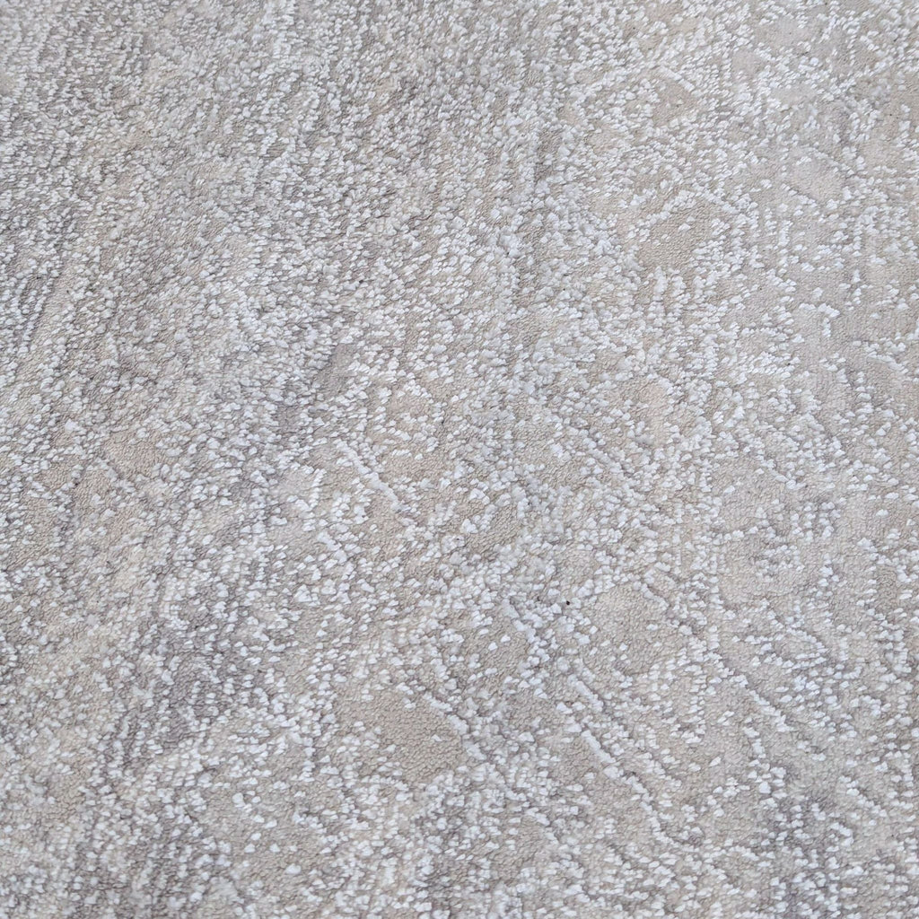 3. Detailed shot of the Calvin Klein rug's modern design, featuring a gentle, understated pattern in grey tones.