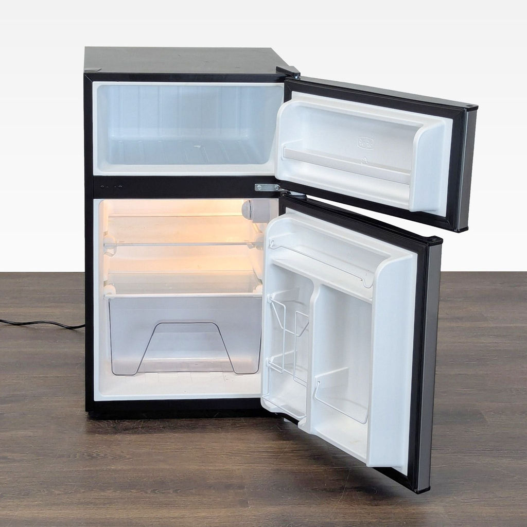 Silver Whirlpool compact fridge, featuring adjustable shelves, crisper drawer, and door storage for easy organization.