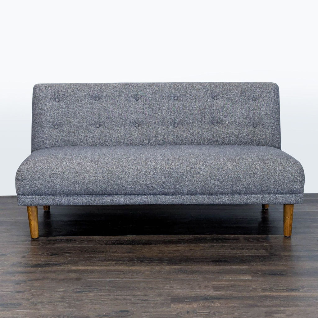 Jason Furniture modern loveseat with gray fabric, button-tufted back, and wooden legs, seats two people.