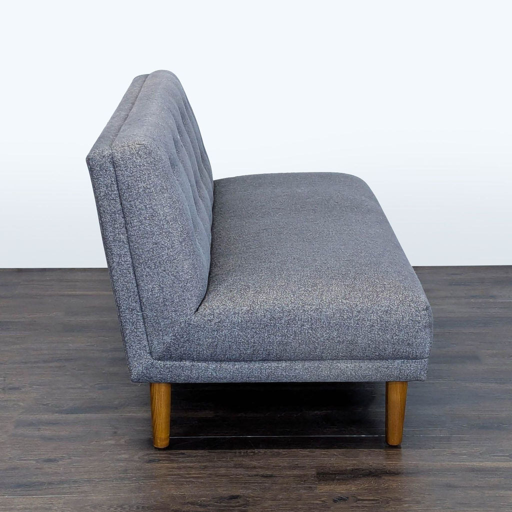 Button-tufted gray Jason Furniture loveseat with sturdy wooden legs, perfect for living rooms or bedrooms.