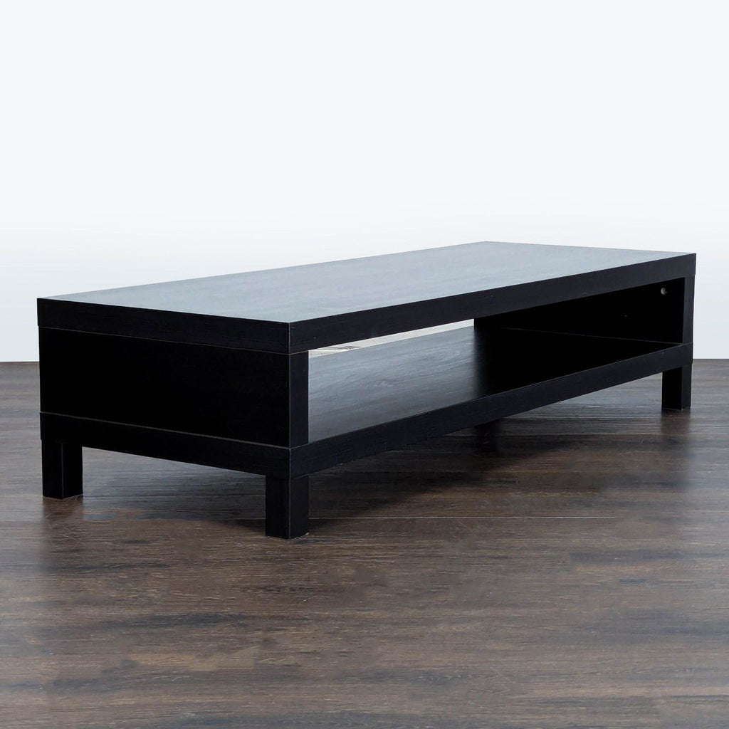 3. Modern black IKEA entertainment center with open storage, angled side view, placed on dark floor.