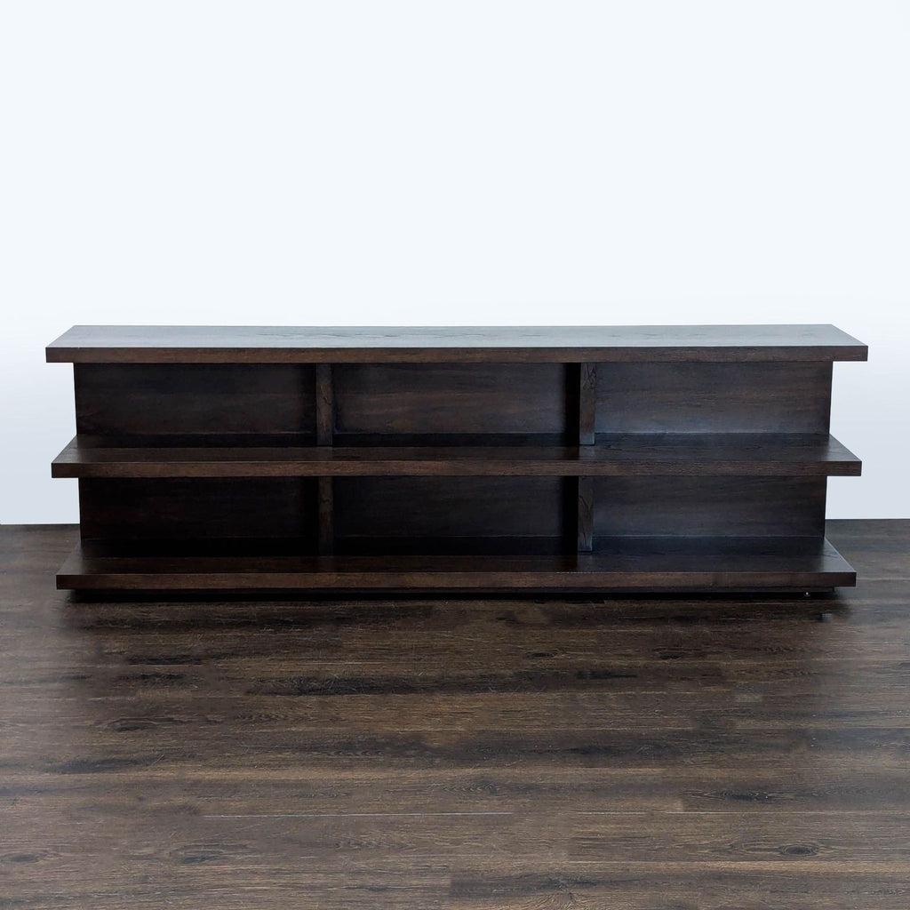 Dark wood bookshelf with three open shelves, modern design, suitable for books or decor in any room.