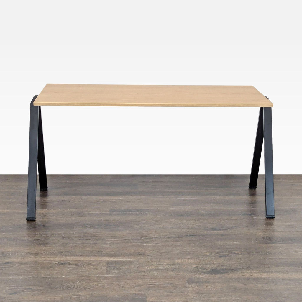 Minimalist Bernhardt desk featuring a spacious light wood surface and sturdy black metal frame.
