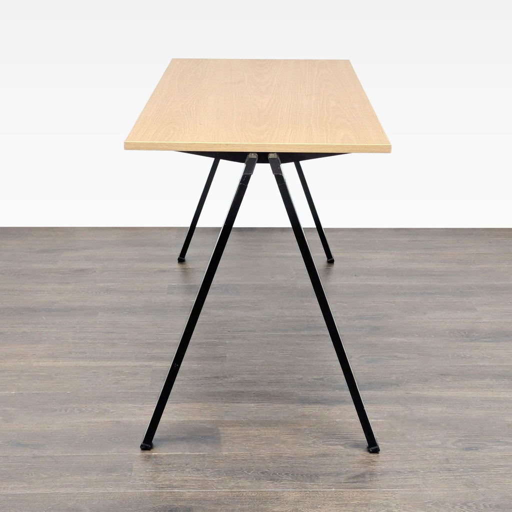 Contemporary Bernhardt desk with clean lines, combining a light wood finish and durable black metal legs.