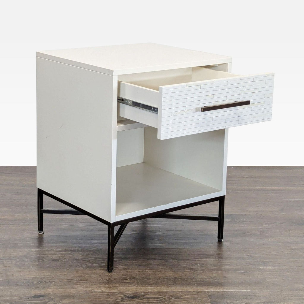 2. Side angle of a West Elm end table showing open hand-inlaid drawer and spacious open shelf, on metal legs.