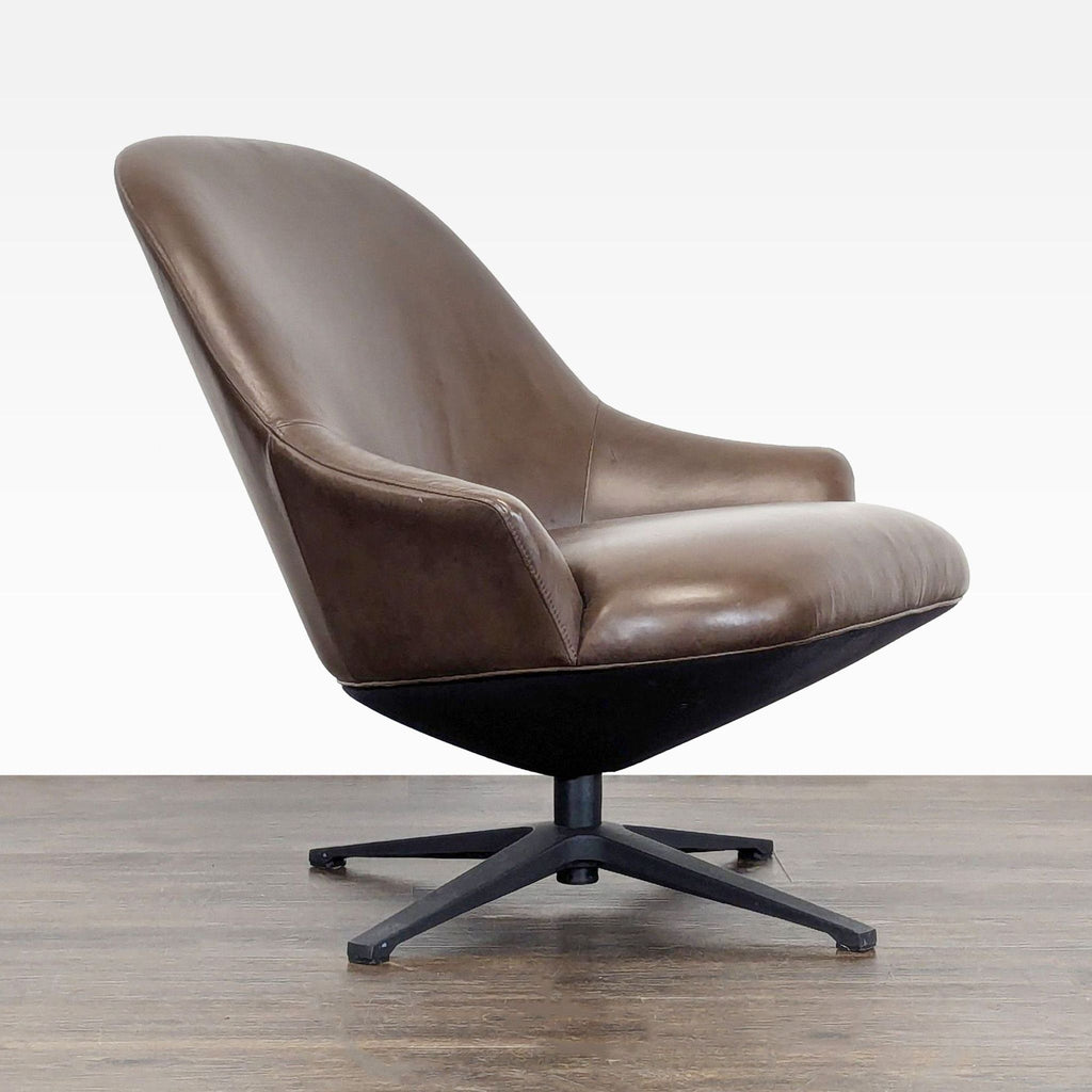Side angle of brown leather Article lounge chair, showing wide seat, curved backrest, and sleek black swivel legs.