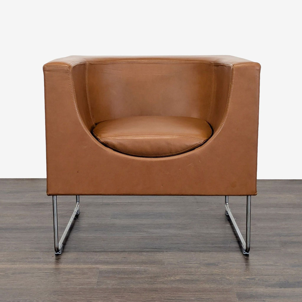 STUA lounge chair with a rounded brown leather seat and chrome legs, offering a modern look for lounges.