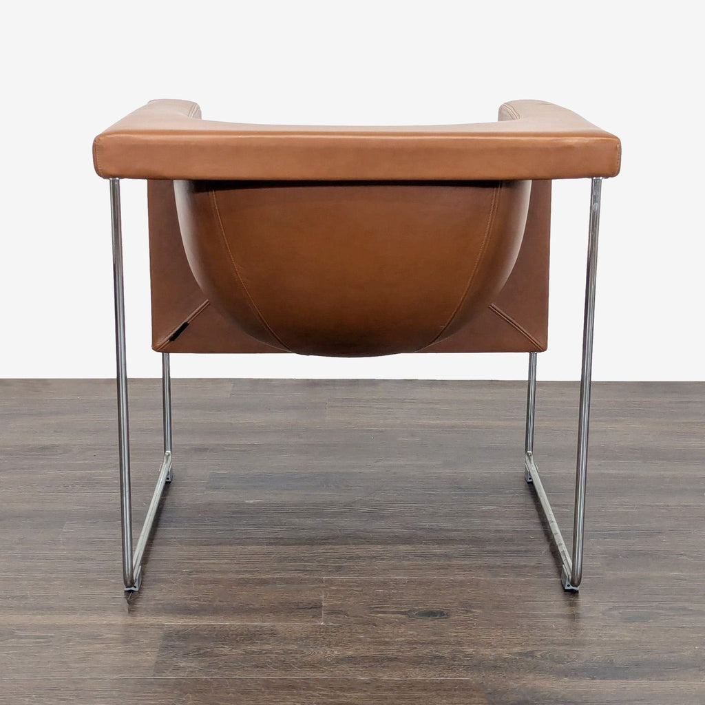 Contemporary lounge chair by STUA, brown leather seat with sleek chrome legs, blending comfort and style.