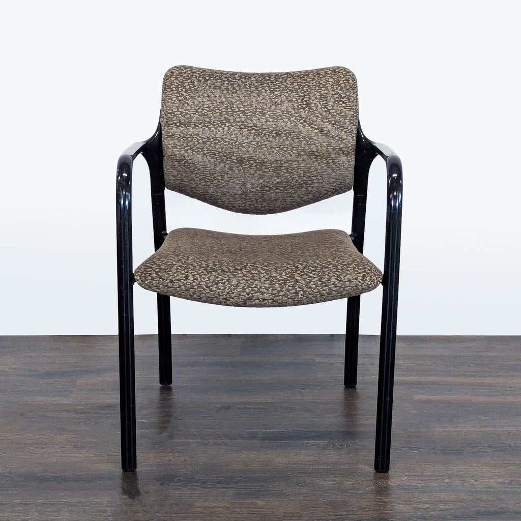 Herman Miller office guest chair with brown patterned upholstery, black metal frame, and padded armrests.