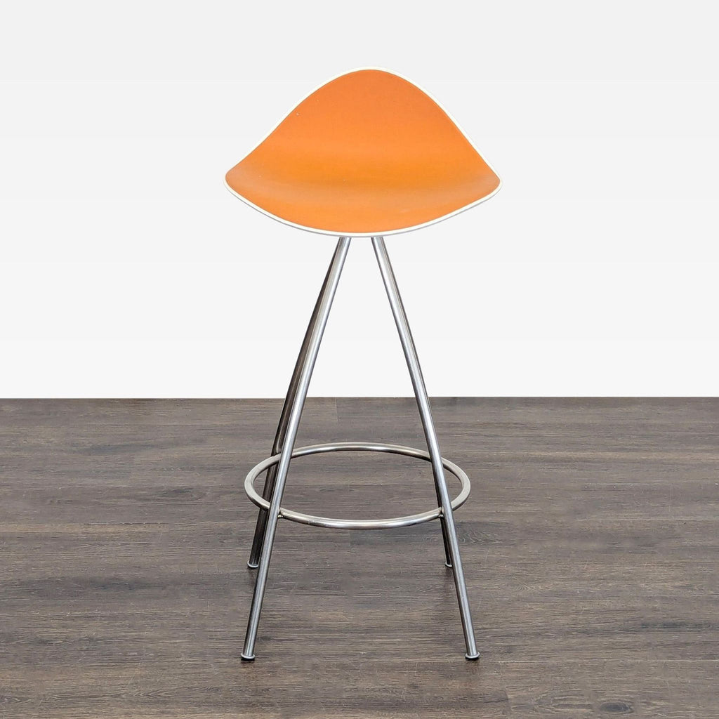1. Modern orange Stua stool with curved seat and metal legs, shown on a wood floor against a plain background.