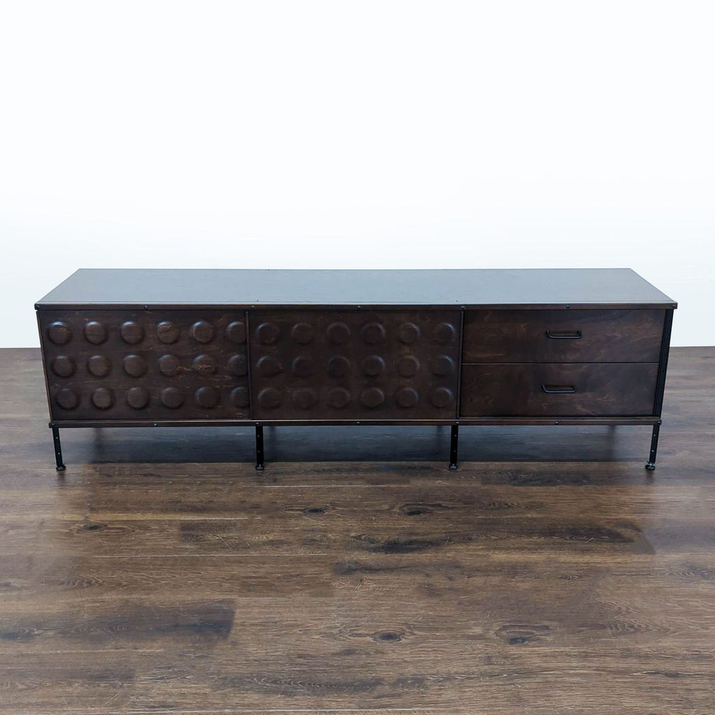 Modernica Eames-style storage unit with painted panels, dimpled plywood doors, and black steel supports.