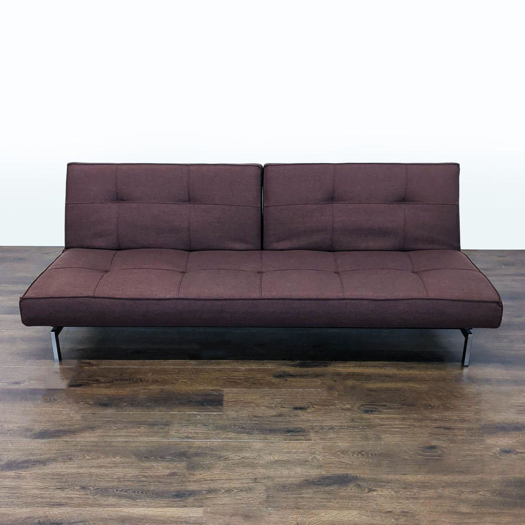 Modern brown Innovation brand sofa with metal legs, convertible to a bed for versatile living spaces.