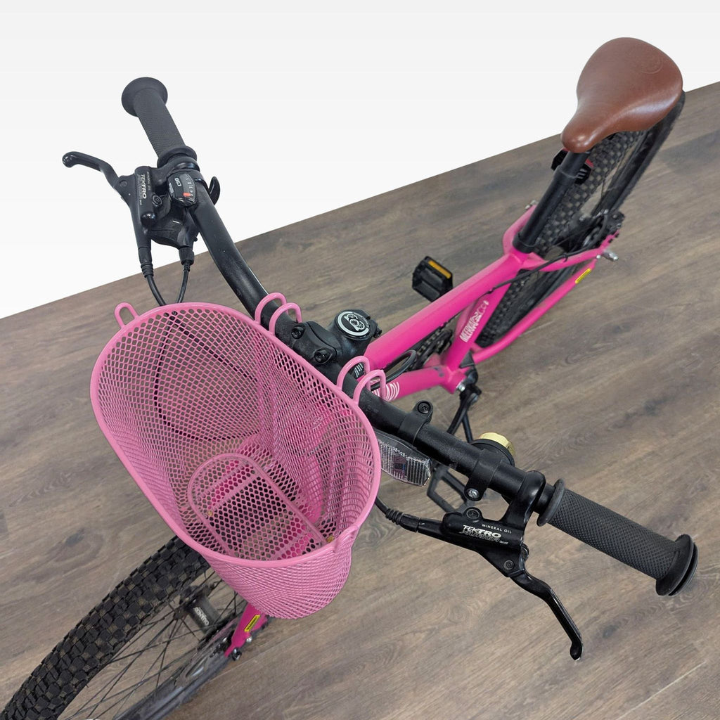 24-inch pink Cleary bike for kids; includes disc brakes, front basket, brown seat, and kickstand for easy parking.