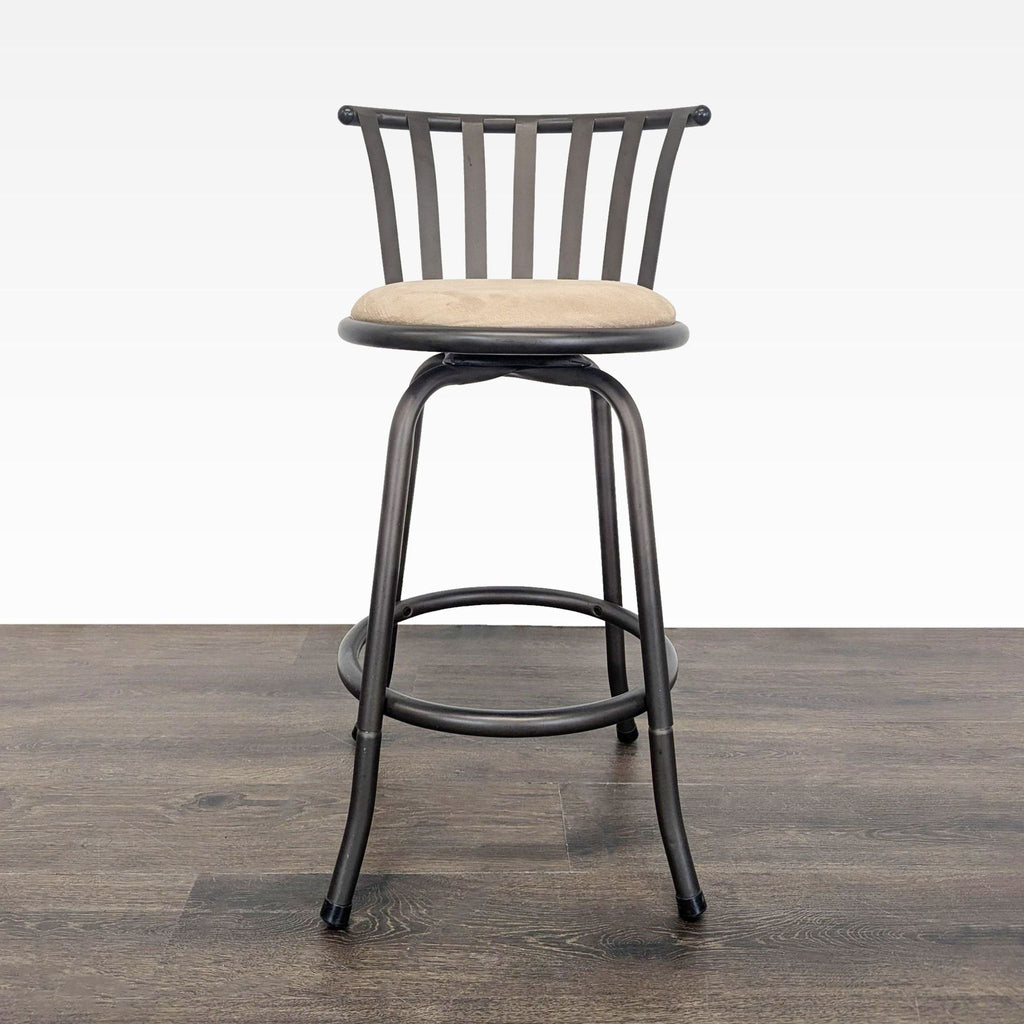 Black metal swivel stool with slatted back and round beige cushion, shown on a wood floor.  