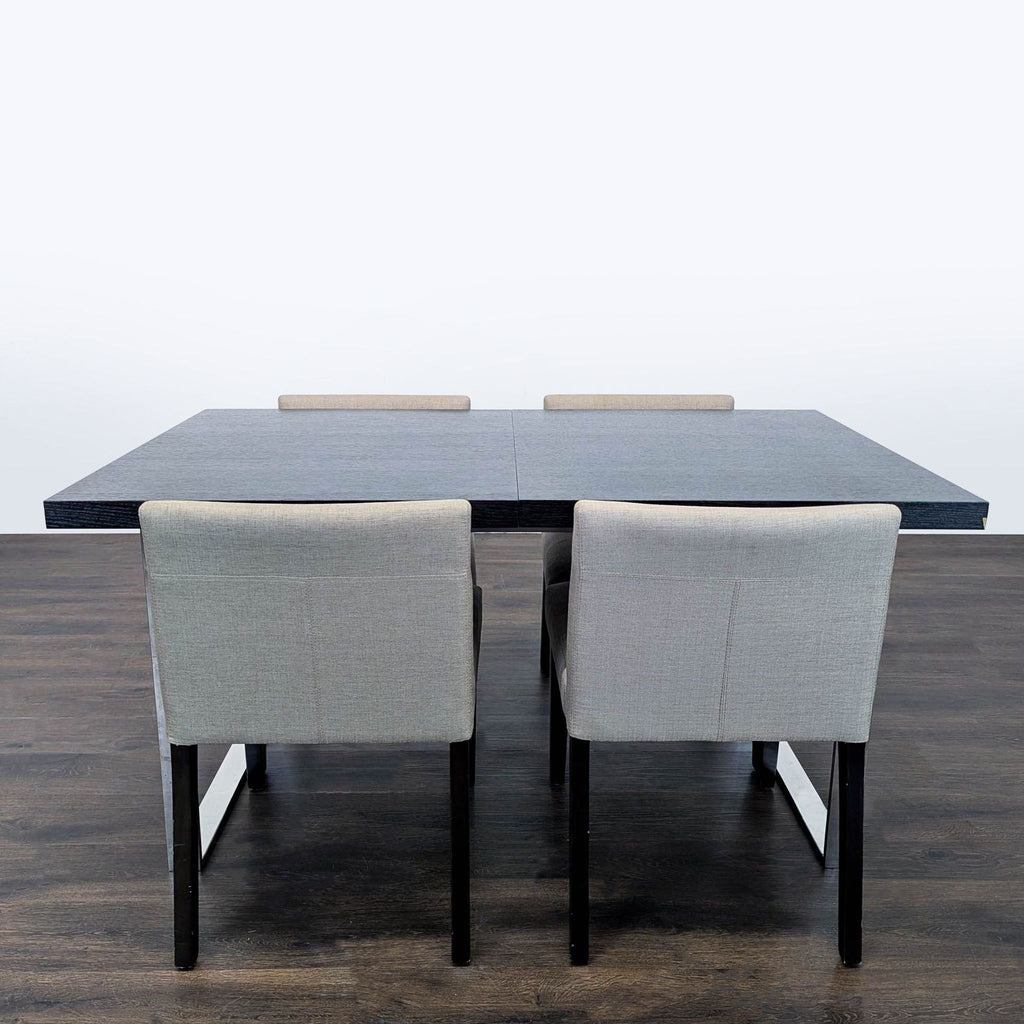 EQ3 dining set with a modern dark wood rectangular table and chrome legs, plus four light-grey chairs.