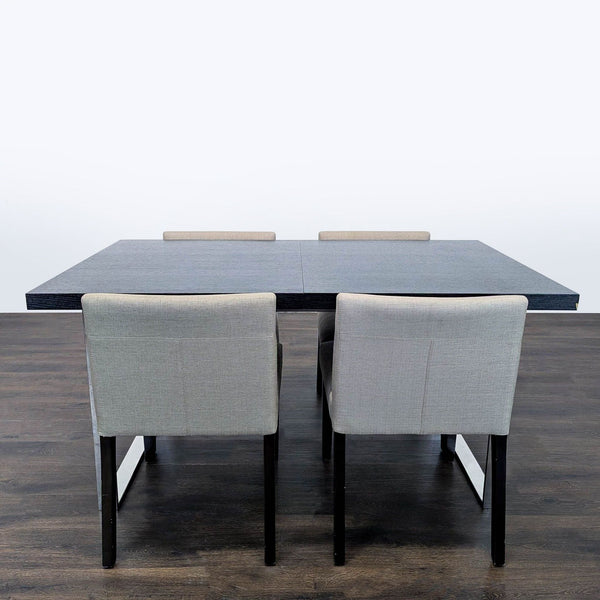EQ3 dining set with a modern dark wood rectangular table and chrome legs, plus four light-grey chairs.