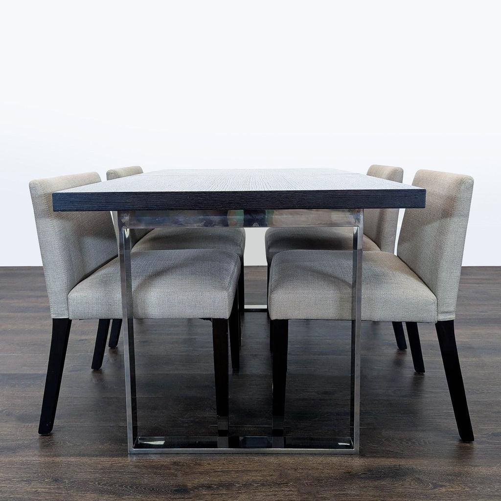 Sleek EQ3 dining set: dark wood table with leaf, chrome legs, and four light-grey upholstered chairs.