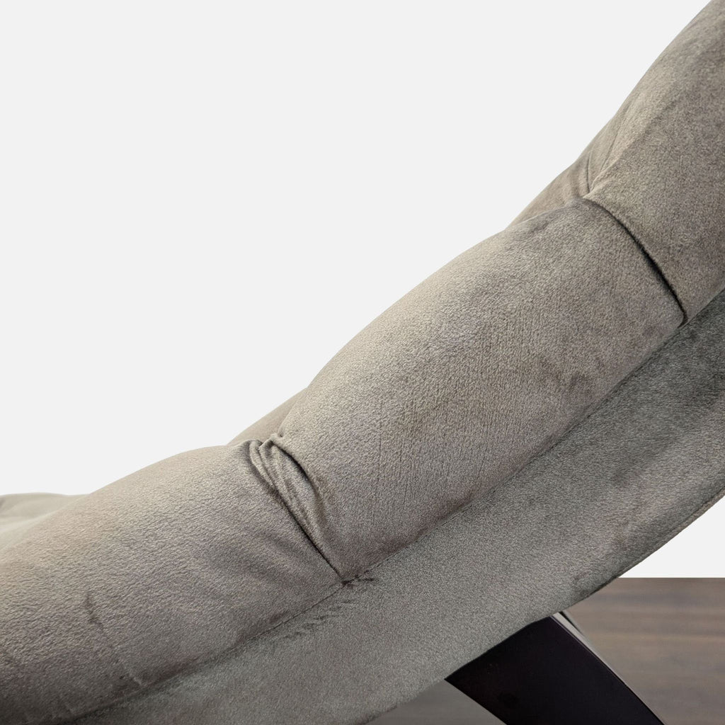 Modern lounge chair in gray velvet with tufted details, suitable for living rooms or bedrooms.