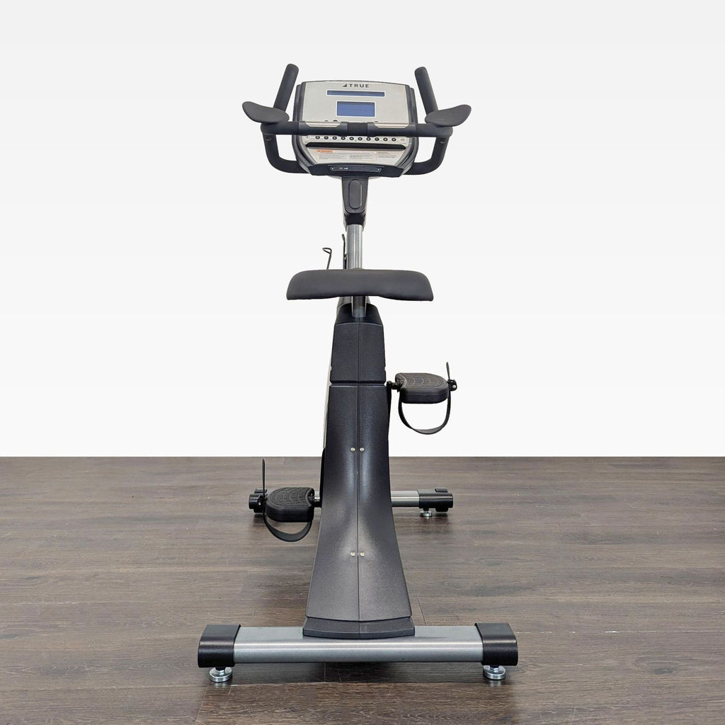 Sleek True brand gym bike featuring a comfortable seat, intuitive console, and quiet ride for all fitness levels.