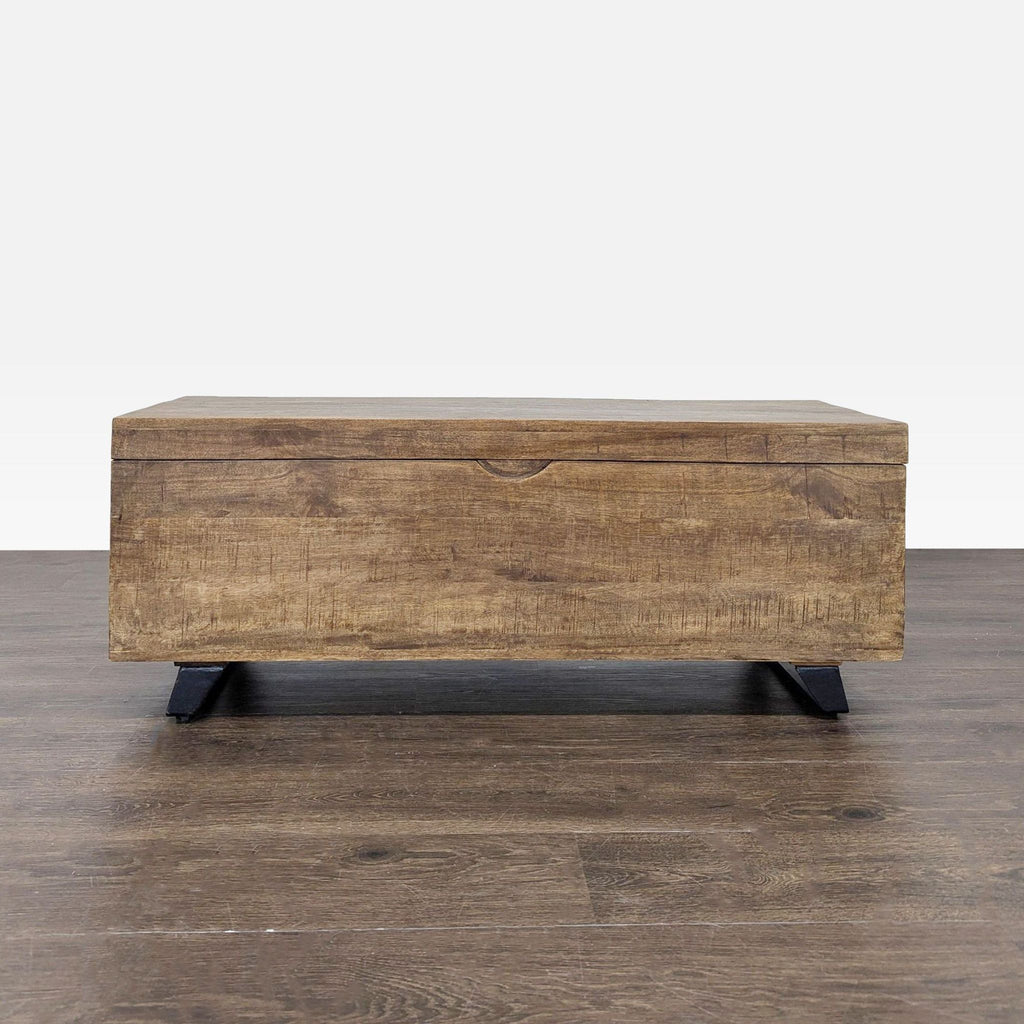 1. Rectangular wooden trunk with a natural finish and black legs, closed and placed on a wood floor.