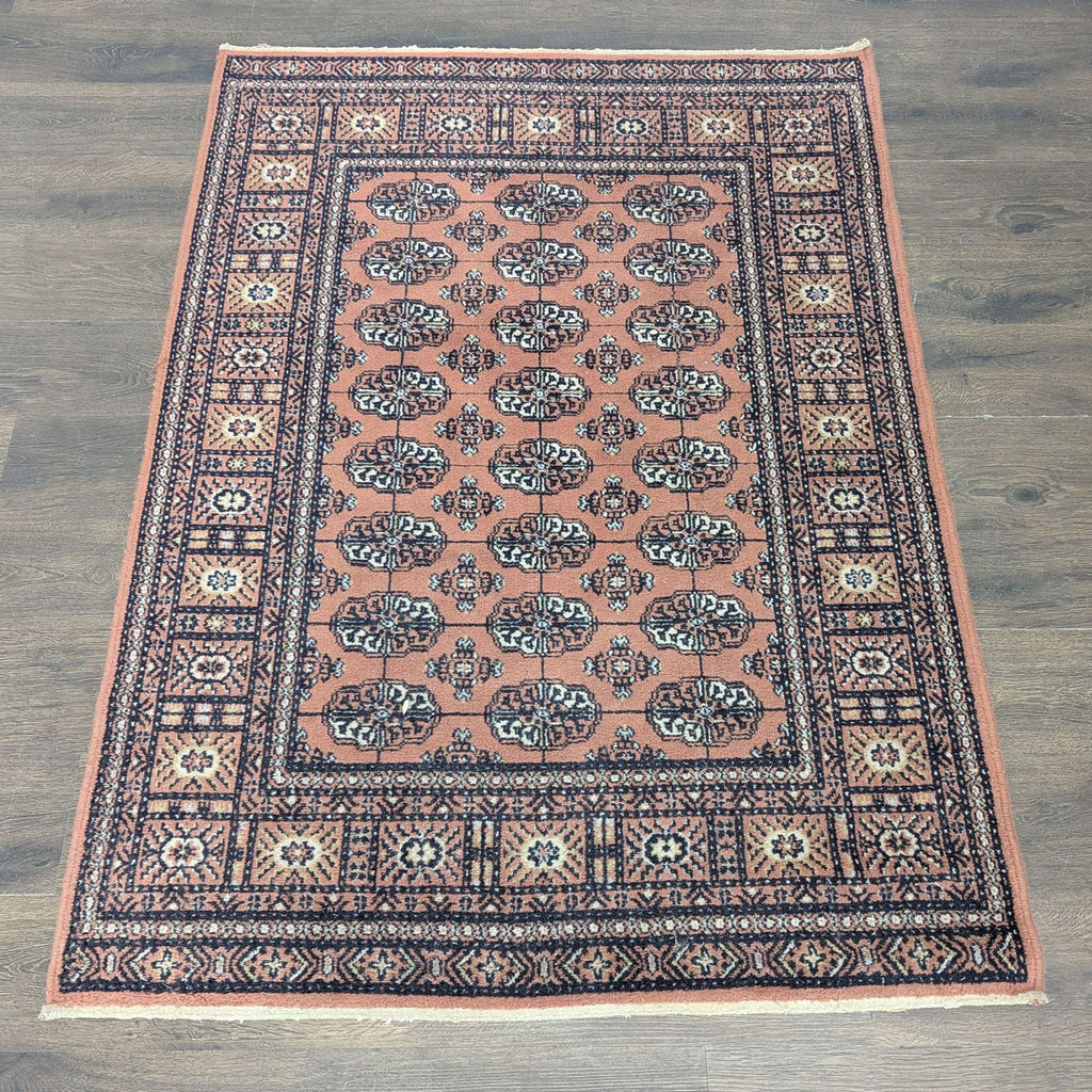Caspian rug with a classic floral and geometric design in rust, black, and cream tones.