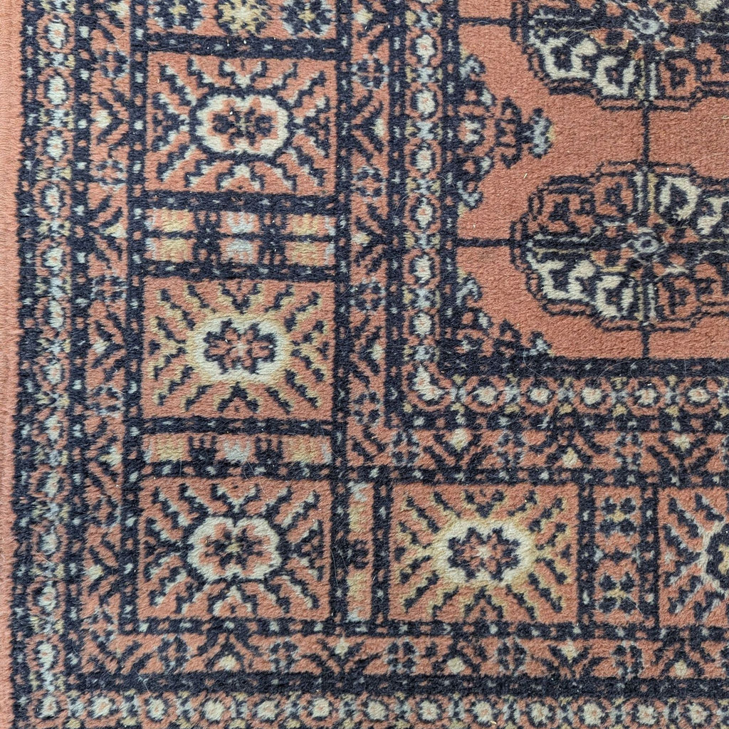 Detailed Caspian rug featuring a rich rust background with black and cream decorative accents.