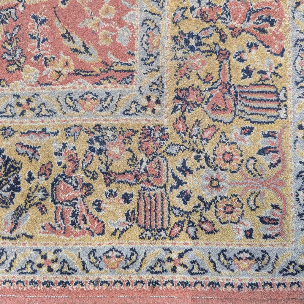 2. Close-up of Couristan rug border, showing gold background with detailed floral and figure motifs.
