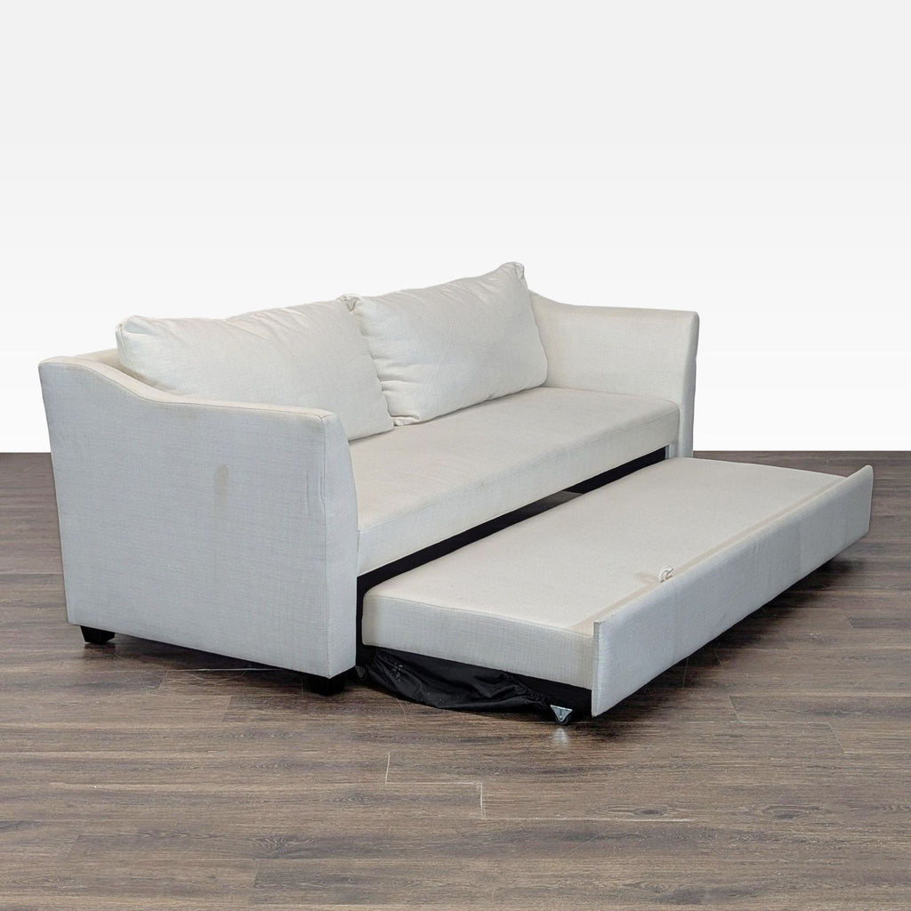 Neutral Pottery Barn sleeper sofa featuring comfortable seating and a space-saving pull-out bed for guests.