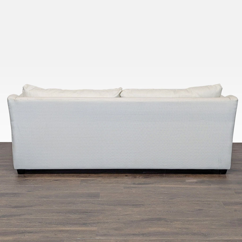 Cream-colored Pottery Barn sofa doubles as a sleeper, blending easily with various decor styles in any room.