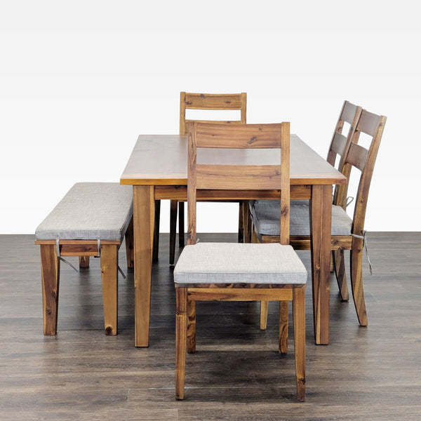 Terrace Living Company dining set with wood table, four chairs, and bench, all with light gray cushions.
