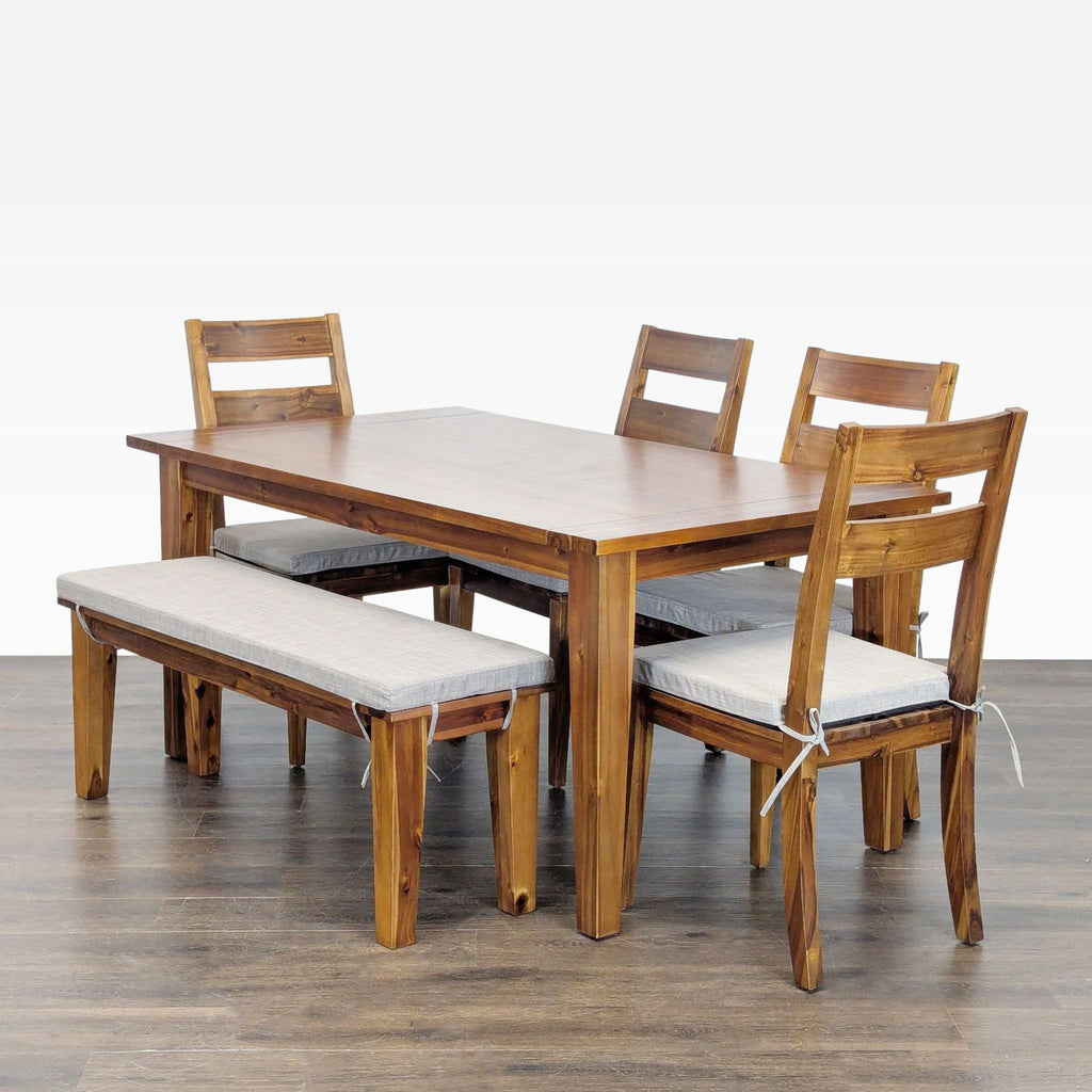 Light gray cushioned dining set by Terrace Living Company, featuring a wooden table, four chairs, and a bench.