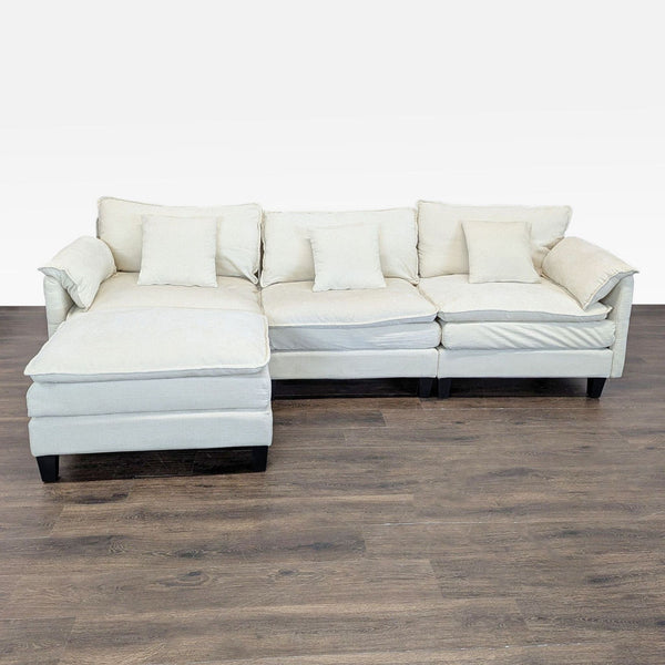 3-seat beige sectional sofa with chaise lounge, five cushions, and modern design, ideal for living rooms.