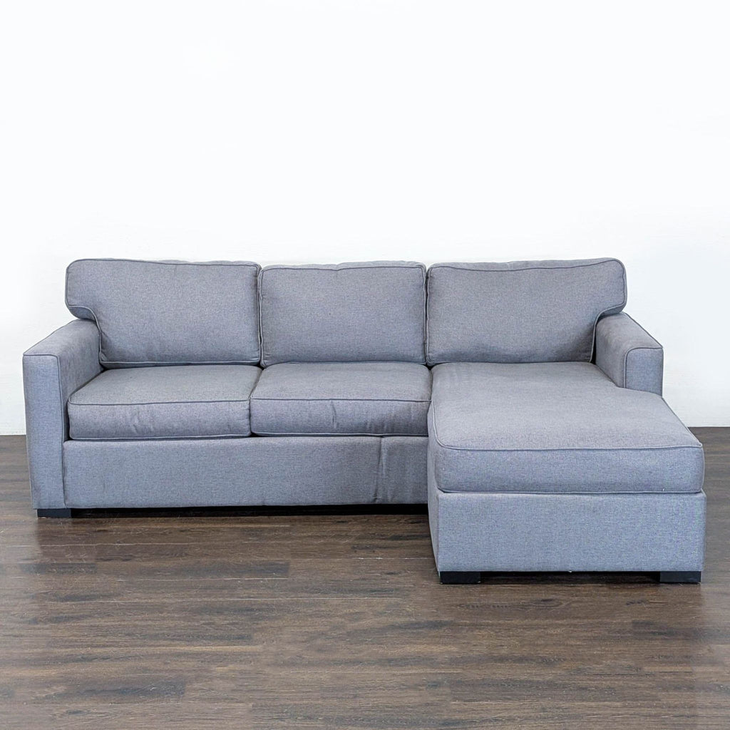 1. Gray Jonathan Louis sectional with right-facing chaise, firm cushions, and modern style on wood flooring.