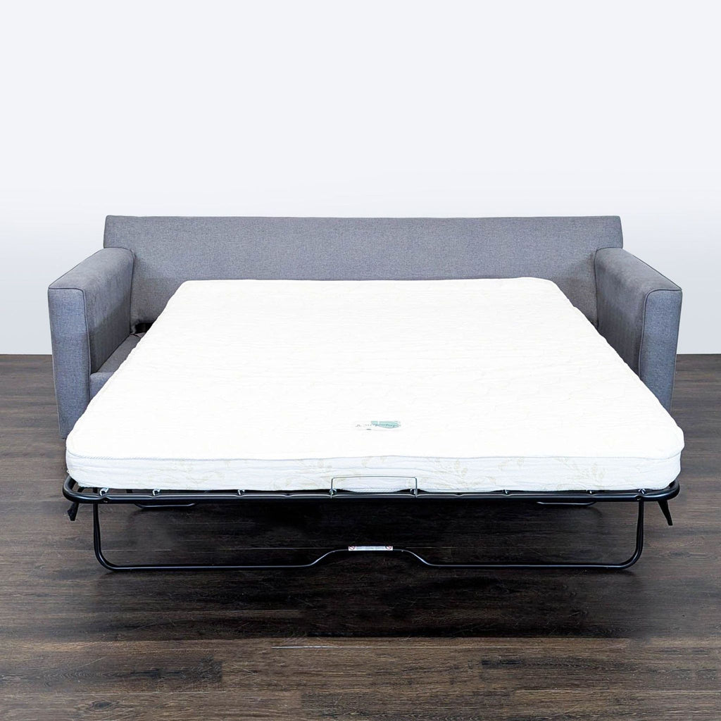 2. Jonathan Louis sectional with pull-out sleeper bed, shown open with a white mattress extended.